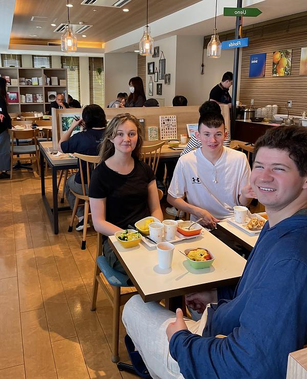 Three students sitting together at breakfast