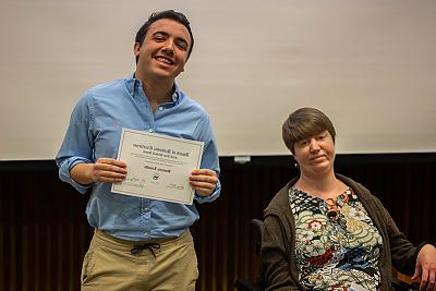 Student 多米尼克Limaldi holding the First Year Student Award, 站在凯蒂·罗克莫尔教授旁边.